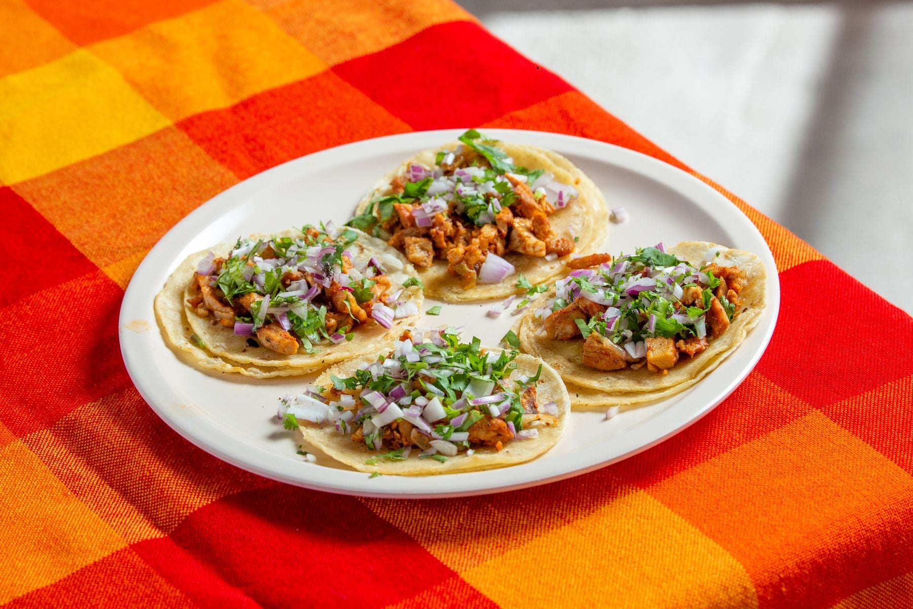 Homemade chicken tacos with cilantro and onion