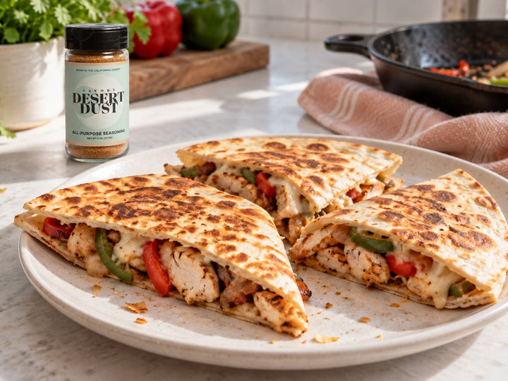 Chicken fajita quesadilla wedges with peppers and cheese, with Savory Desert Dust nearby.