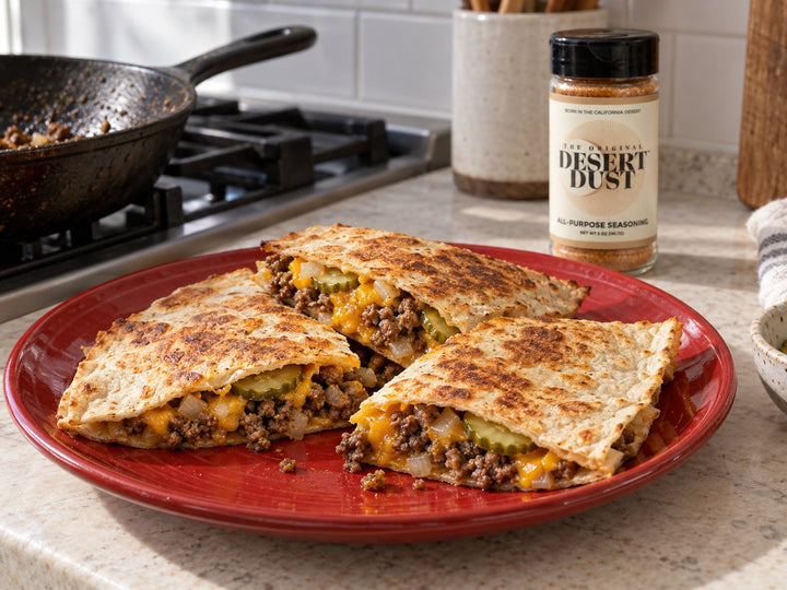 Cheeseburger quesadilla wedges with beef, cheddar and dill pickles beside Original Desert Dust.