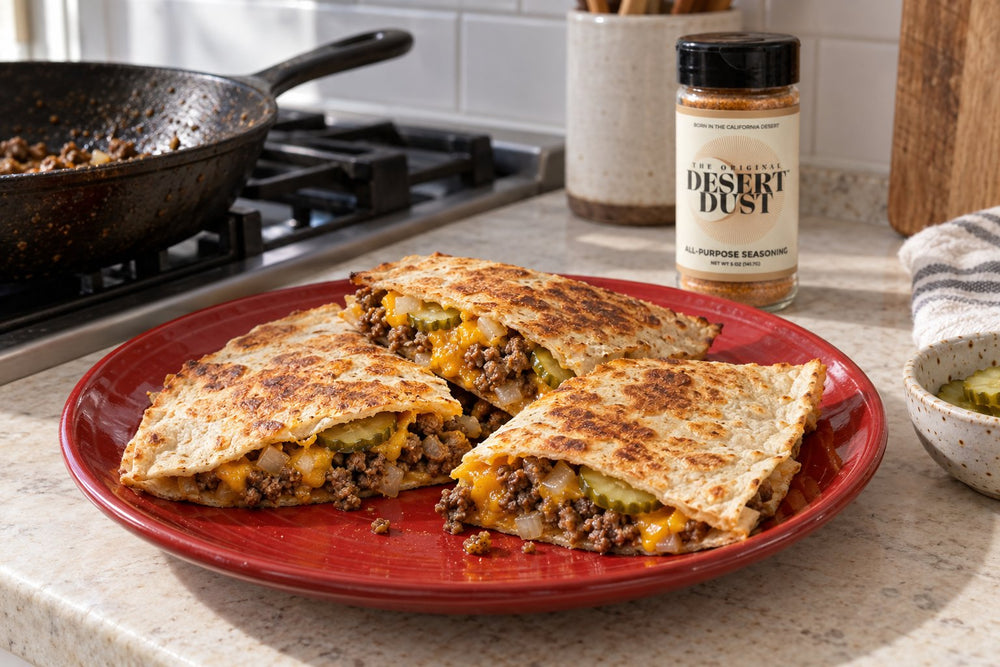 Cheeseburger quesadilla wedges with beef, cheddar and dill pickles beside Original Desert Dust.