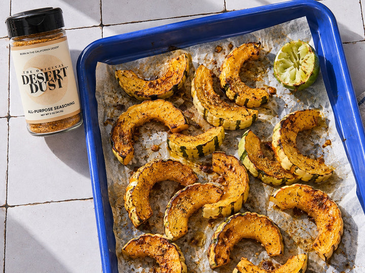 Roasted delicata squash in a blue enamel tray with Original Desert Dust