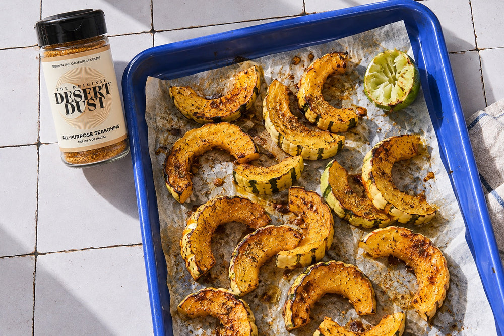 Roasted delicata squash in a blue enamel tray with Original Desert Dust
