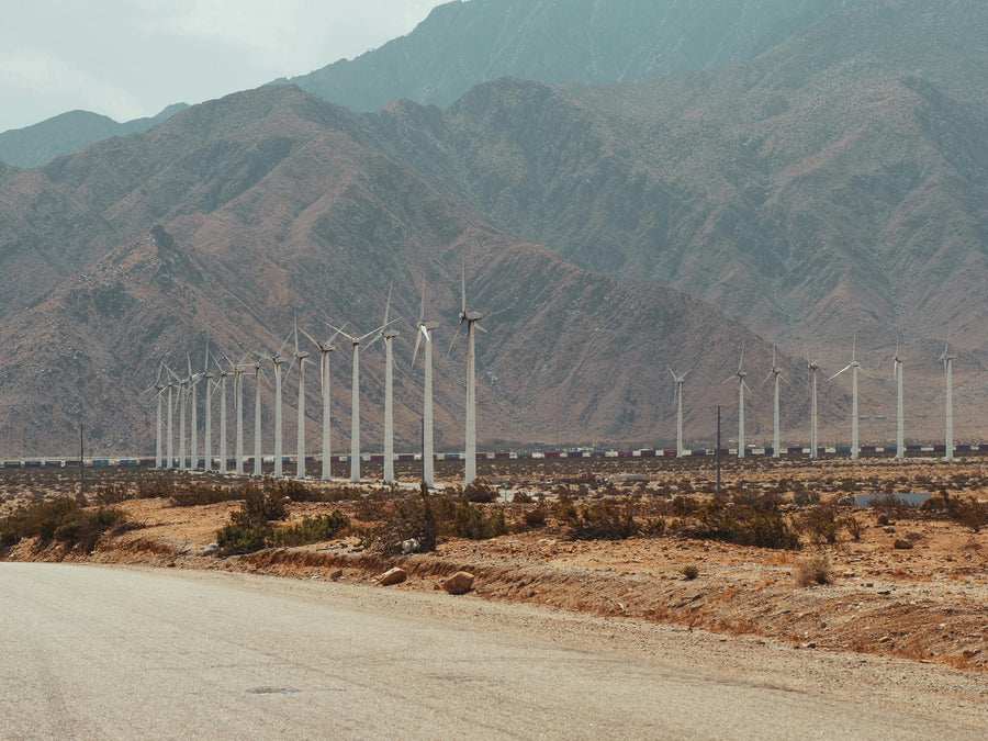 Wind turbines below desert mountains near Palm Springs