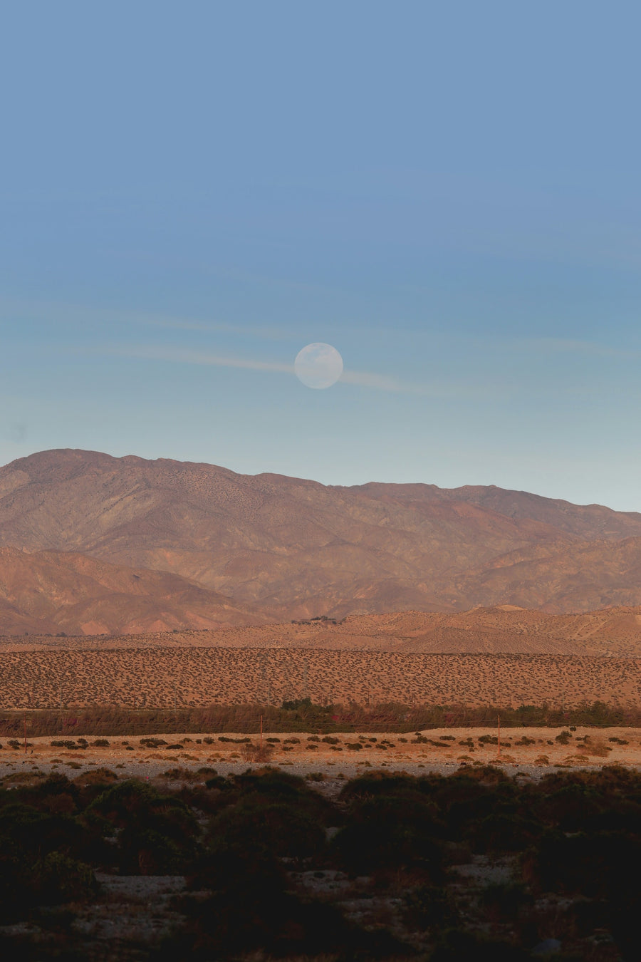 Moonrise over quiet desert mountains