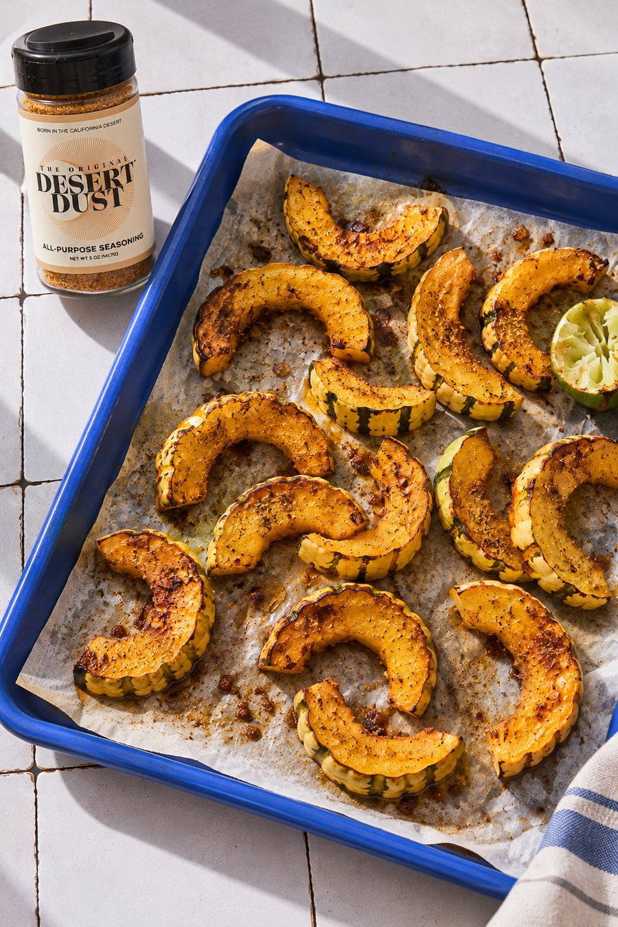 Roasted delicata squash in a blue enamel tray with Original Desert Dust