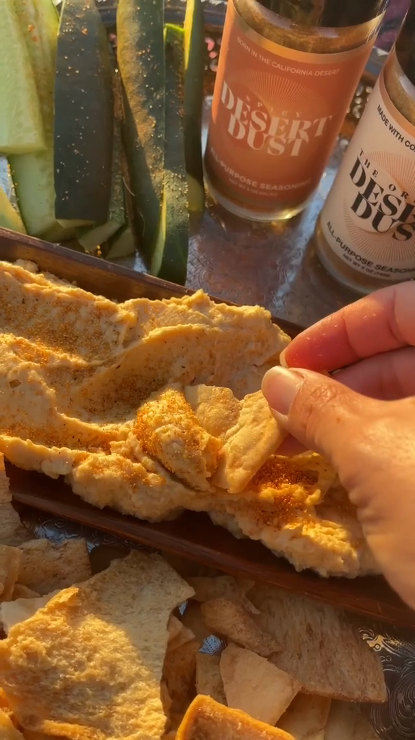 A chip dipped into a golden-hour picnic spread