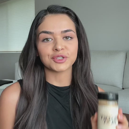 A person holding a Desert Dust seasoning bottle