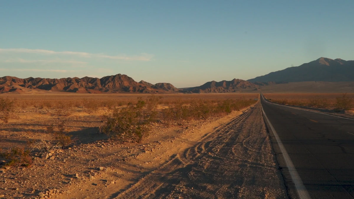 An open road through a desert landscape